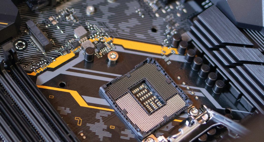 Close-up of a computer motherboard showcasing the CPU socket and various electronic components.